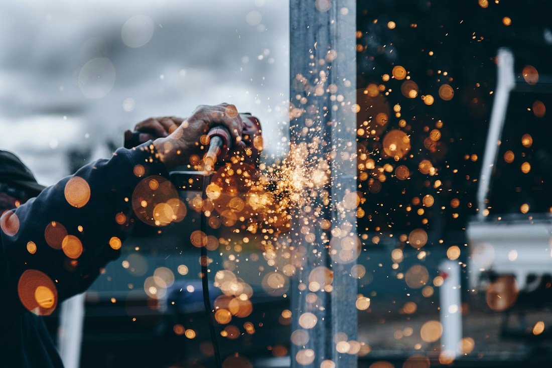 Workshop tooling in use with sparks against a dark background